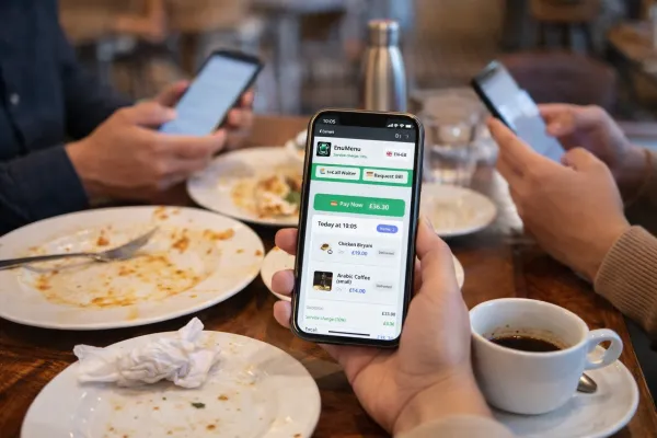 Customers ordering from their phones at a restaurant table